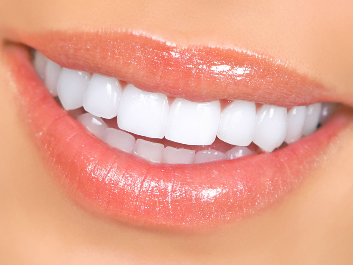 woman smiling with lip gloss